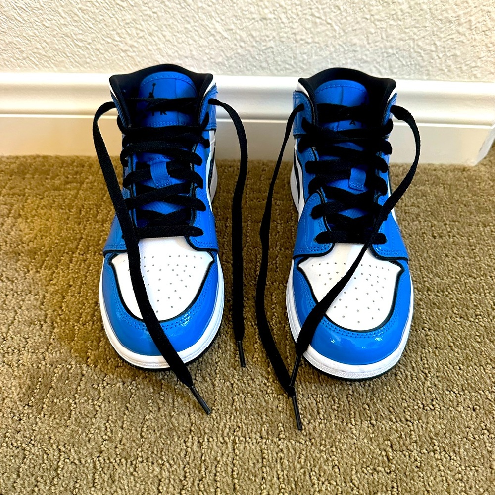 Nike Air Jordan’s. Size 5 in women. patent blue, black and white. mid tops.